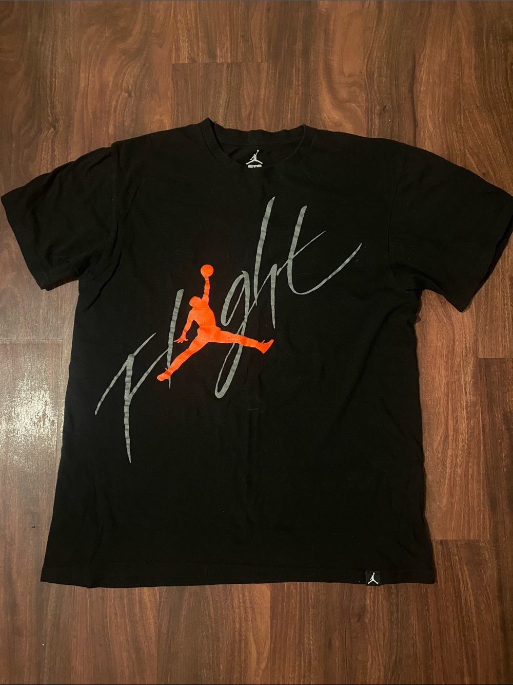 Jordan Men’s Black Tee with Orange Jumpman and Gray Flight Script